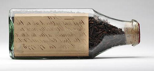 Tea leaves in glass bottle collected on the shore of Dorchester Neck the morning of 17 December 1773 Glass bottle containing tea